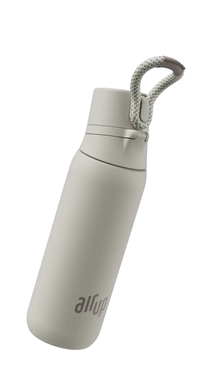air up® bottle opening next to a peach